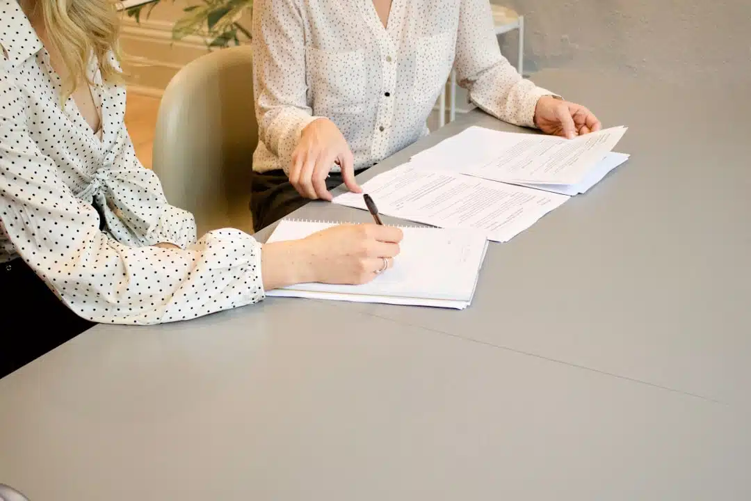 People reviewing and signing business documents.