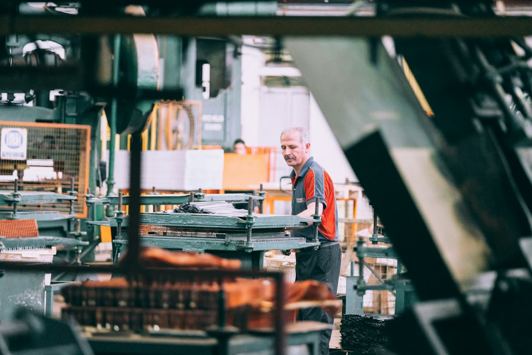 Small manufacturing machinery and operator, illustrating supply-chain growth and production.