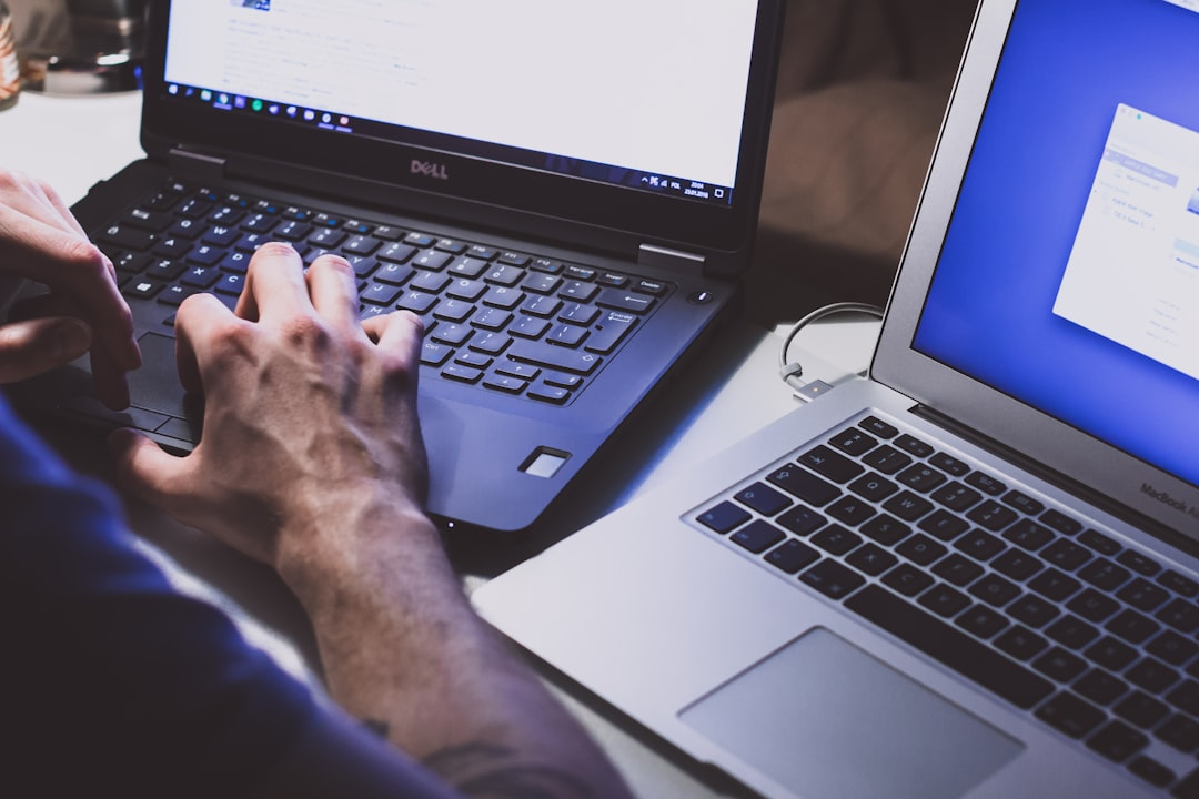 Person working on a laptop, illustrating invoice verification, phishing awareness, and a repeatable small-business approval process.