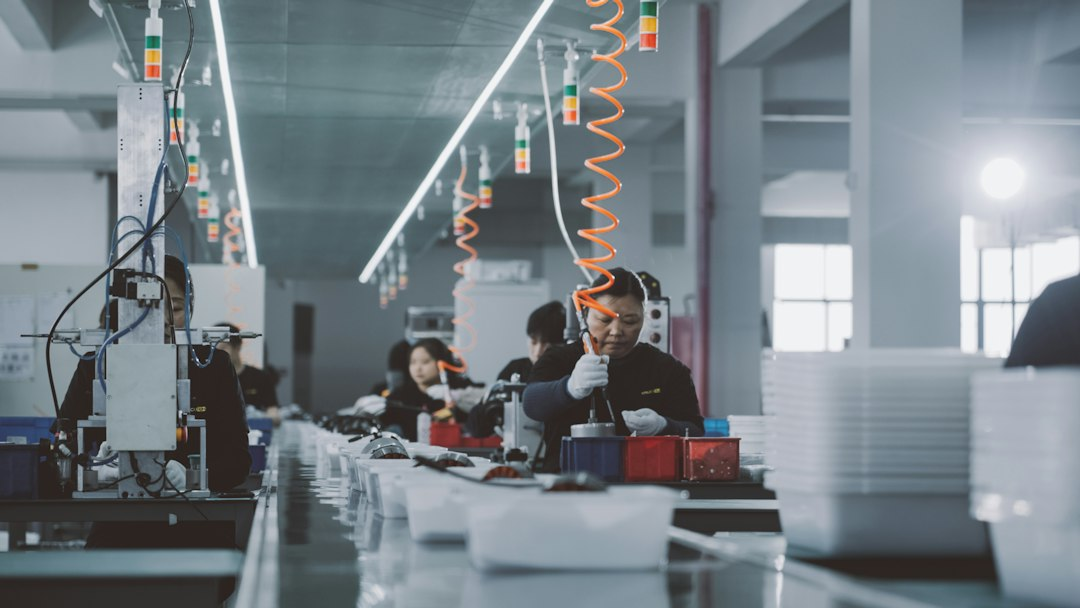 People working in a manufacturing environment, representing production and supply-chain capability.